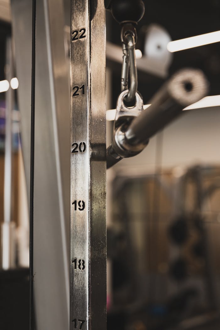 Close-up shot of a gym equipment weight stack in a fitness center.